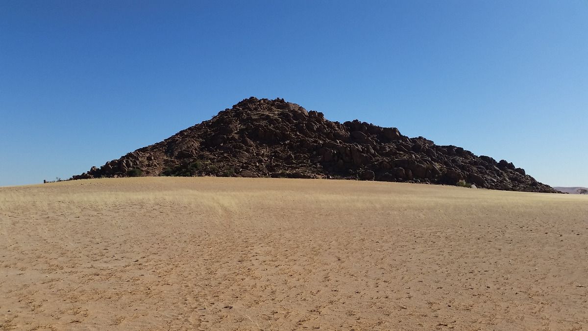 Namibia: Granite mountain behind 'Desert Camp' on the D826